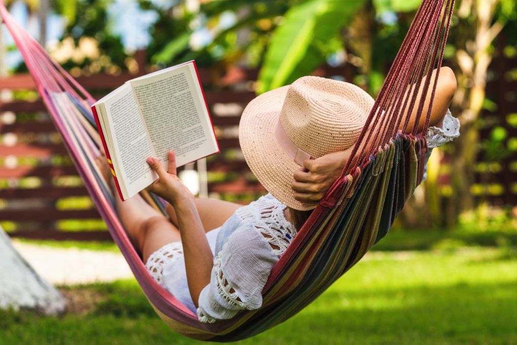 Lady reading a book in a hammock
