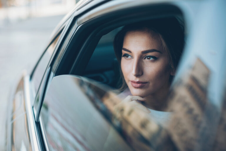 Serious looking out of a car window